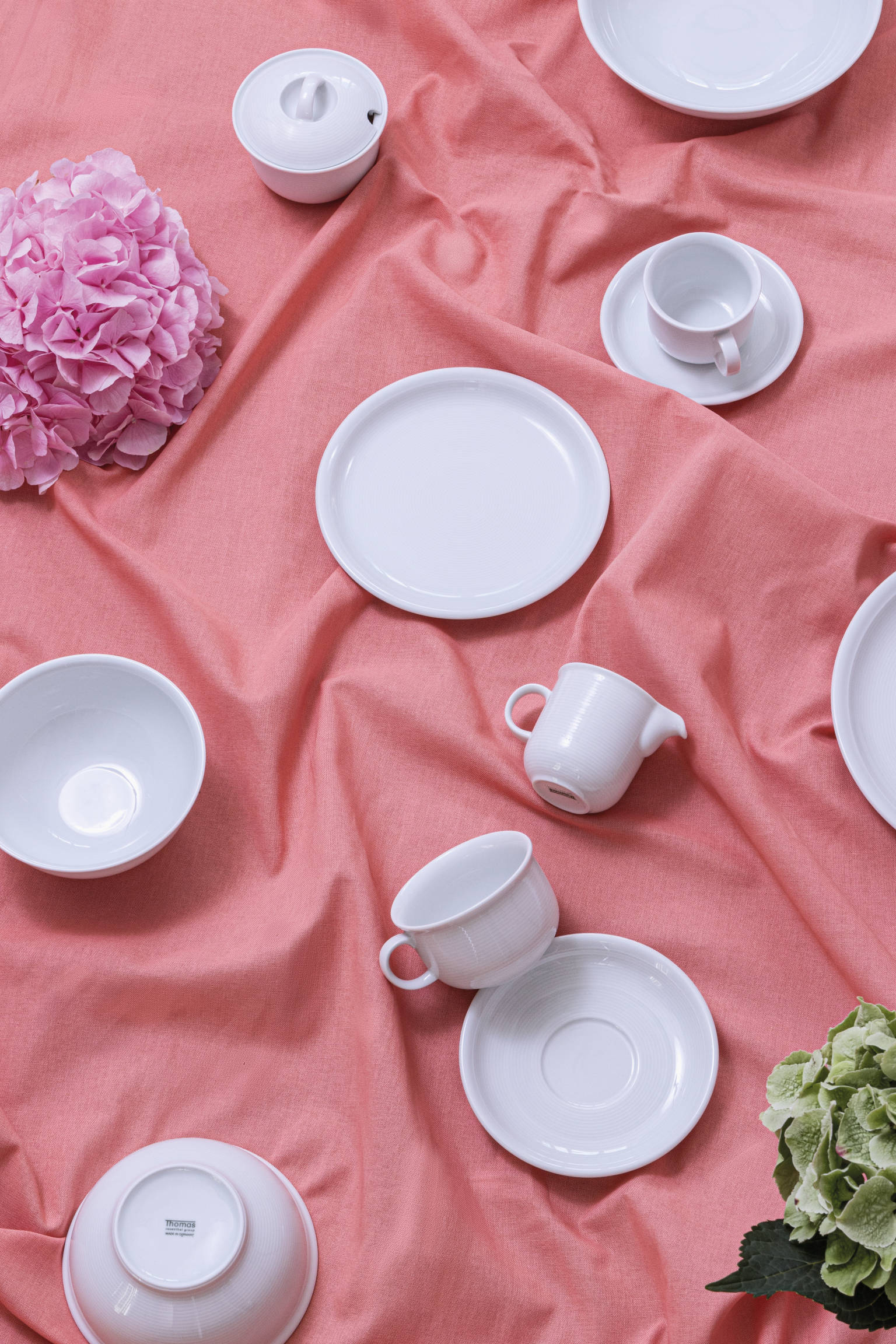 Thomas Trend White items scattered on rose tablecloth